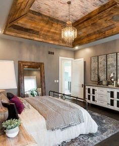 a bedroom with a bed, dresser and mirror on the wall next to each other