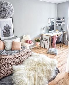 a bedroom with a bed, desk and pictures on the wall in it's corner