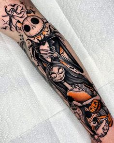 a person with a tattoo on their arm that has an image of a woman and skeleton