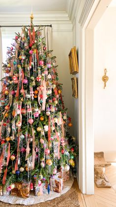 a christmas tree decorated with ornaments and ribbons