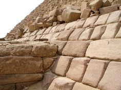 a close up of the side of a pyramid with rocks on it's sides
