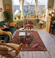 a living room filled with furniture and lots of plants in the window sills