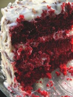 a slice of red velvet cake with white frosting