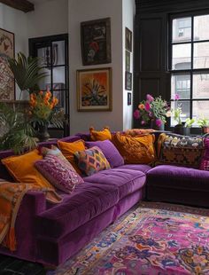 a living room filled with purple couches and colorful pillows