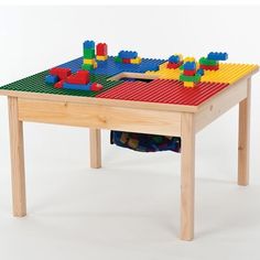 a child's table made out of legos and wooden pegs on top