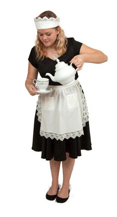 a woman dressed in black and white holding a tea pot