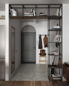 an entry way with bookshelves and shelves