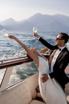 a man and woman on a boat holding wine glasses