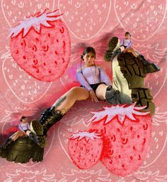 two women in short shorts and boots are sitting on a strawberry shaped piece of paper