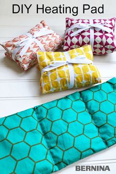 four different colored pillows sitting next to each other on top of a white table with text overlay that says diy heating pad