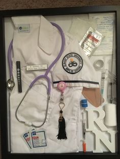 a framed medical kit with a stethoscope, nurse's cap and other items