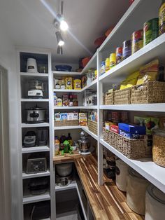 an organized pantry with lots of food and containers on the shelves, including bread boxes