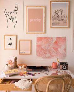 a white desk topped with lots of pictures and art