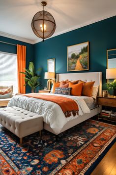 a bedroom with blue walls and orange accents