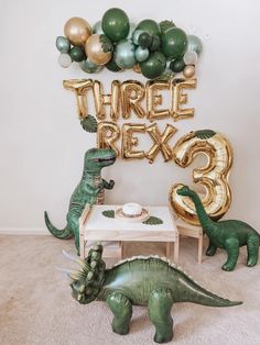 there are balloons that say three peas and two dinos in front of the table