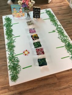 a table with flowers and cards on it that have been made to look like a game