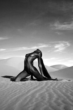 black and white photograph of naked woman in the desert