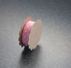 a roll of pink and white polka dot tape with an owl design on the side