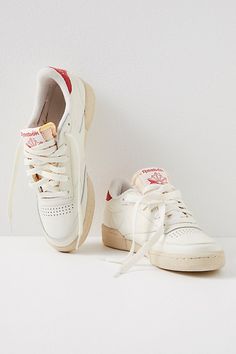 A classic court style infused with retro flair, complete with leather uppers, terry lining, and faded rubber outsoles. **Features:** Low-top style, leather uppers, perforated toe box, removable EVA foam sockliner die-cut EVA midsole, durable rubber outsole, lace-up closure, logo details, terry lining **Why We | Reebok Club C 85 Vintage Sneakers at Free People in White, Size: US 8 Reebok Club C 85 Vintage, Reebok Club C Vintage, Reebok Club C, Reebok Club C 85 Outfit, Reebok Sneakers, Reebok Shoes, Reebok Classic Club C 85, Reebok Club, Reebok White Sneakers