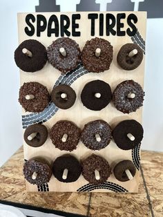 a wooden sign with chocolate donuts on it and the words spare tires above them