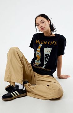 Step up your graphic tee rotation with the new Miller High Life T-Shirt from Junk Food. Crafted for both comfort and style, this tee effortlessly combines retro flair with a touch of casual coolness.


	Solid color tee
	Short sleeves
	Crew neckline
	Front graphic
	Relaxed fit
	100% cotton
	Machine washable
	Model is wearing a size small
	Model measurements: 5’7.5” height, 32” bust, 23” waist, 35” hip Casual, Outfits, Clothes, Graphic Tee Outfits, Shirt, Tshirt Under Dress Outfit, Junk Food, How To Wear, High Life