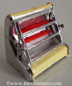 a close up of a toaster on a white surface with red items in it