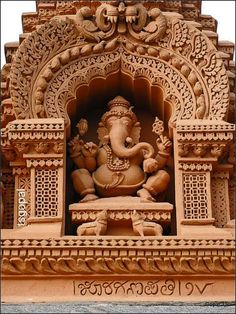 an intricately carved ganesha sculpture on the side of a building
