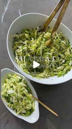 two white bowls filled with shredded cabbage and chopsticks on top of a table