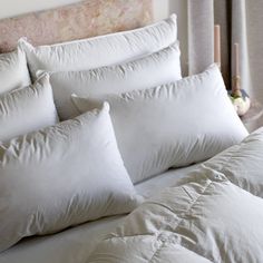 a bed with white pillows on top of it