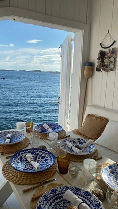the table is set with blue and white plates