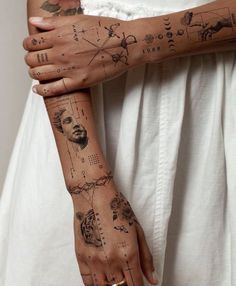 a woman's arm with tattoos on it