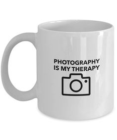 a white coffee mug with the words photography is my therapy