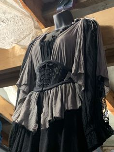 a black dress with ruffles and lace on it