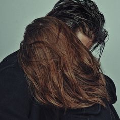 the back of a man's head with long hair