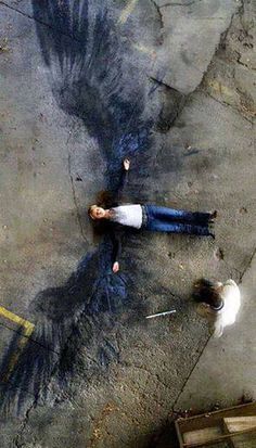 two people laying on the ground next to each other