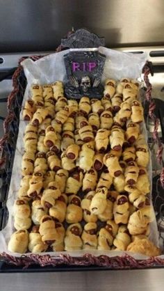 there is a tray full of pigs in a blanket on the stove top with a sign that says rip