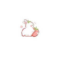 a white rabbit sitting on top of a strawberry