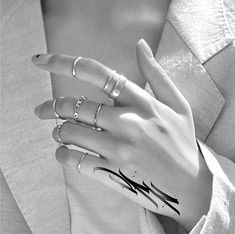 a woman's hand with three rings on it