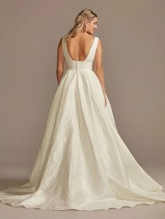 a woman in a white wedding dress is looking back
