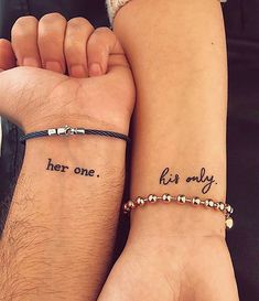 two people holding hands with tattoos on their wrists and the words her one, her only