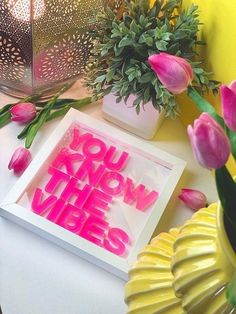 some pink flowers are sitting on a table and there is a card that says you know the vibes