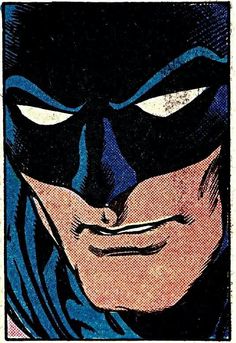 a close up of a person wearing a batman mask