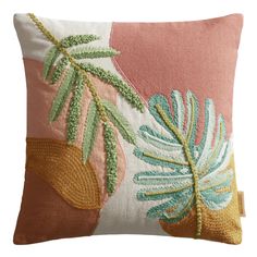 an embroidered pillow with leaves on it