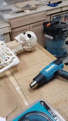 a cordless drill is laying on top of a cardboard box in the process of being assembled