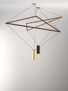 a suspended light fixture with two lights on each side and one hanging from the ceiling