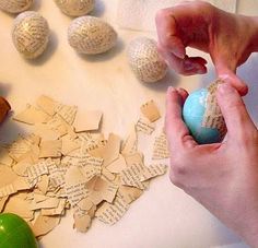 someone is peeling paper from an egg on a table with other items around it and the eggs have been broken