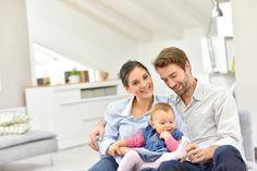 a man and woman sitting on a couch with a baby in their lap text reads fixed rate home loan