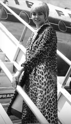 a woman standing on the steps of an airplane