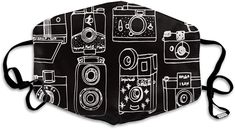 a black and white face mask with camera images on it, all over the front