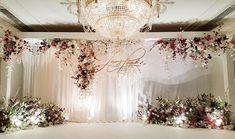 an elegant wedding setup with flowers and chandelier